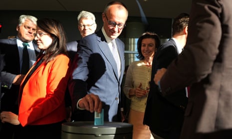 Friedrich Merz, CDU/CSU parliamentary group leader and CDU federal chairman, votes on the amendment of the Basic Law at the German Bundestag, in Berlin.