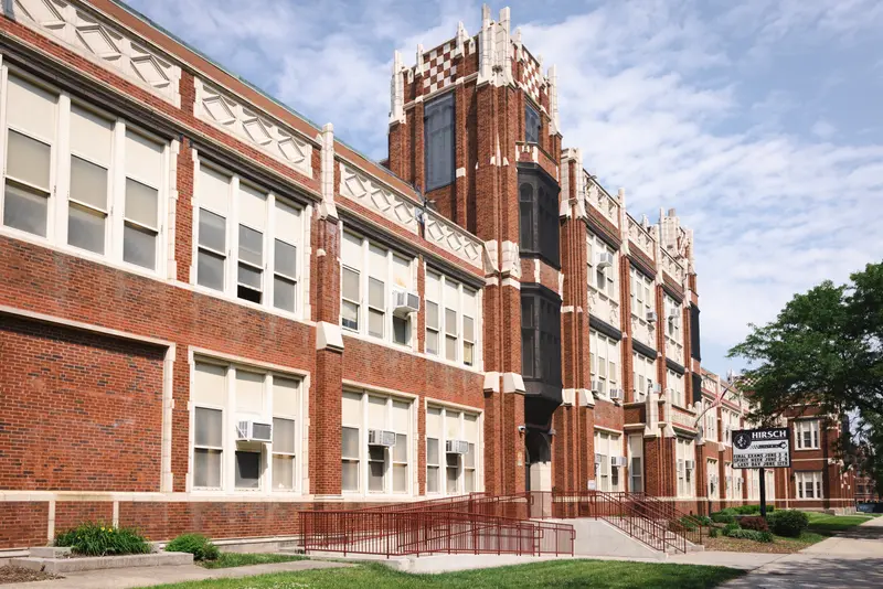 A large red brick building with white accents.