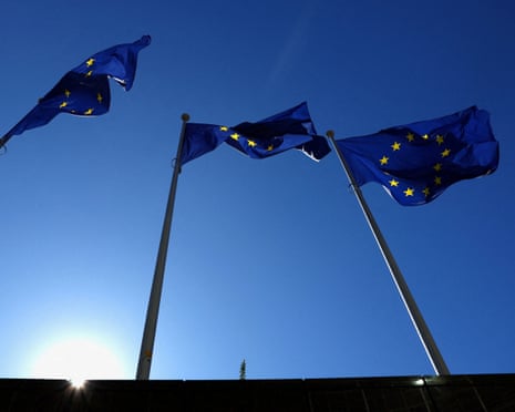 European Union flags flutter outside the EU Commission headquarters in Brussels, Belgium.