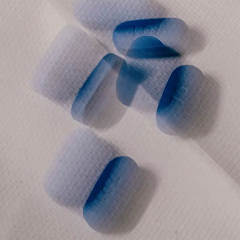 A blurry double exposure of blue pills.