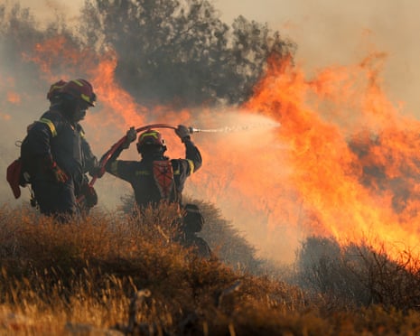 Firefighters try to extinguish a wildfire near Ierapetra, on the island of Crete, Greece.