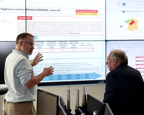 France’s prime minister François Bayrou (R) listens to a weather forecaster of the Meteo France weather agency during a visit at the Centre Operationnel de Gestion Interministerielle des Crises (COGIC - Interdepartmental Crisis Management Operational Center) of the French Interior Ministry in Paris.