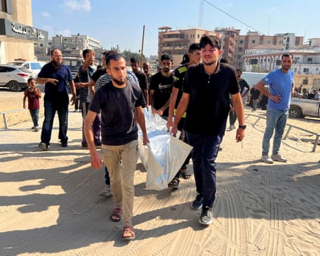 People carry the body of a Palestinian, who according to medics, was killed in overnight Israeli strikes, during a funeral at Nasser hospital in Khan Younis, southern Gaza Strip, 18 July 2025.