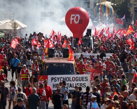 A crowd of people with flags and a large balloon