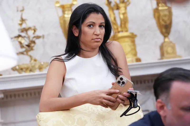 A woman in the Oval Office with a phone in her hand.