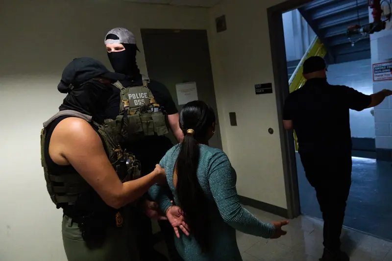First image: People wait in line while an agent in a black mask and hat leans against a wall. Second image: Masked agents restrain the arms of a man wearing glasses and a blue shirt. Third image: Two masked agents wearing hats detain a woman, seen from behind.