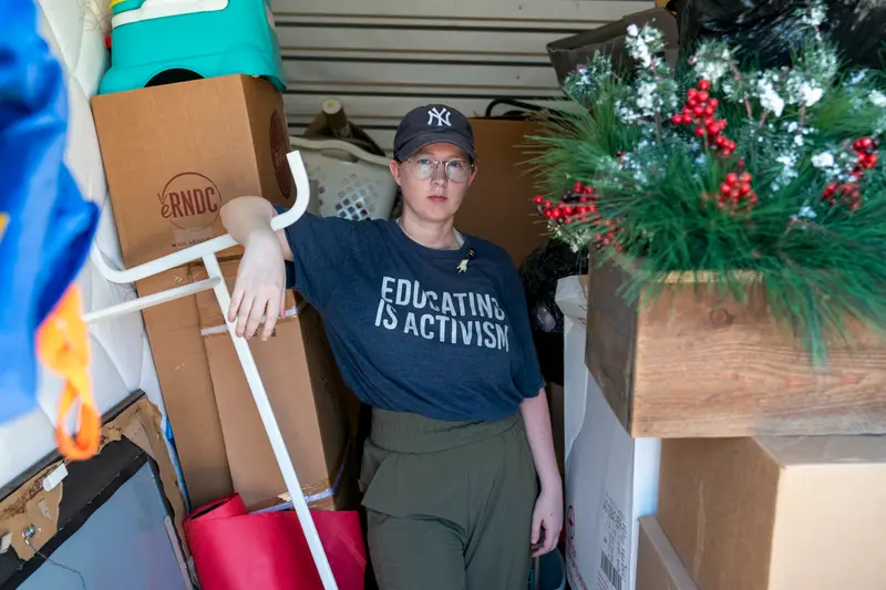 Summer Boismier stands amid boxes and other personal items in her storage unit.