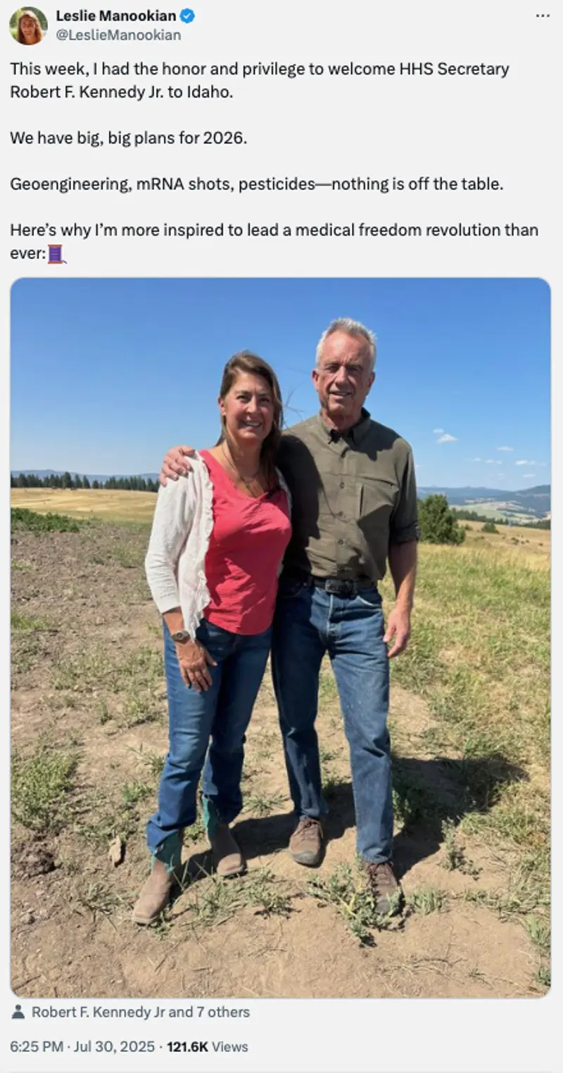 RFK Jr. has his hand around Manookian’s shoulder. They are both standing outside with a mountain and trees in the background.