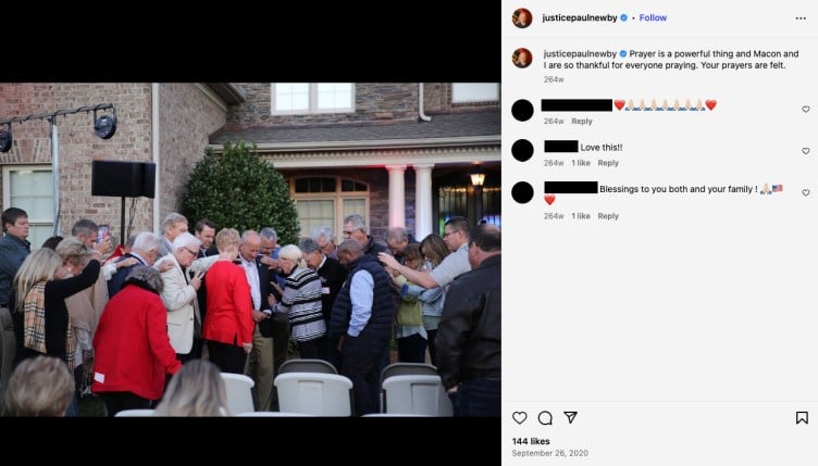 A crowd of people surround Newby with heads bowed and arms touching the shoulders of people in front of them. Newby’s caption reads: “Prayer is a powerful thing and Macon and I are so thankful for everyone praying. Your prayers are felt.”