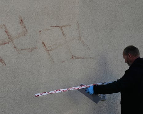 Criminal experts measure swatsikas at a house in Hanau, Germany.