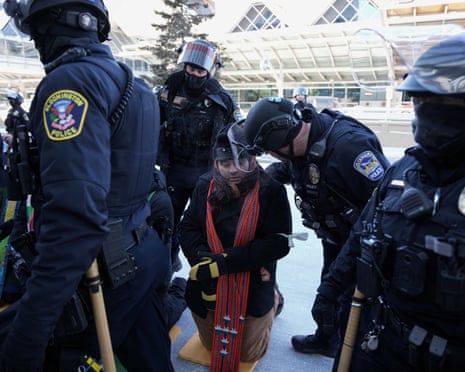 A police officer detains a clergy member, during a rally to protest against the deployment of thousands of immigration enforcement officers on the streets of Minneapolis, Minnesota, 23 January 2026.