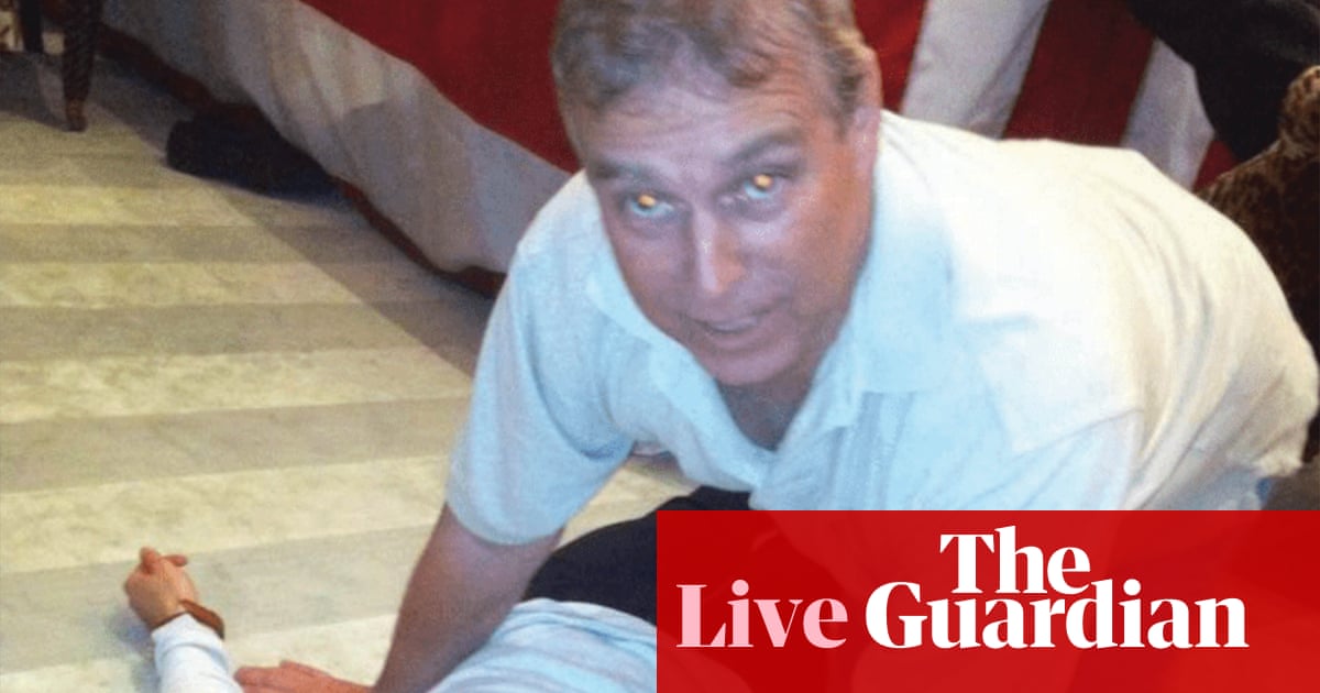 Epstein files latest: photos appear to show former prince Andrew crouching over female | Jeffrey Epstein