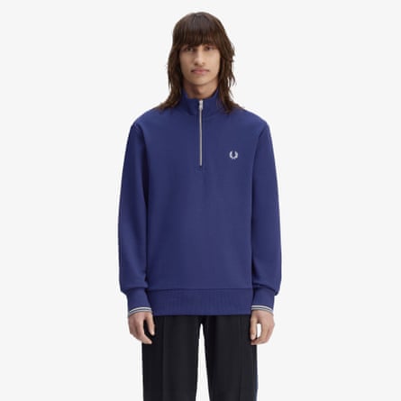 A model wears a royal blue Fred Perry Half Zip Sweatshirt