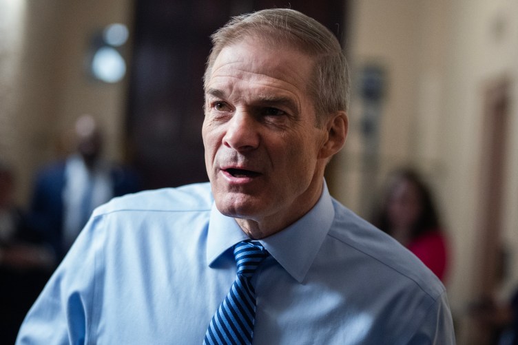 A close-up photo of a man wearing a blue shirt and tie.