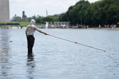 A worker vacuums algae from the Lincoln Memorial Reflecting Pool, after recent renovations following a directive from U.S. President Donald Trump to paint it blue ahead of the 250th anniversary of U.S. Independence, in Washington, D.C., U.S., June 21, 2026.