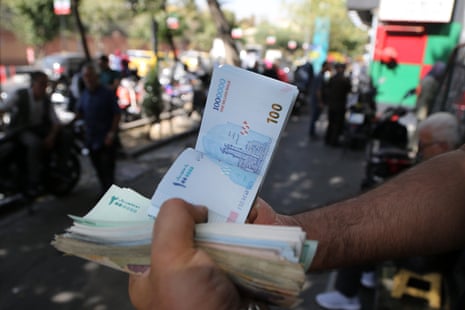 A man who runs a mobile currency exchange office is counting money in Tehran, Iran on 6 October 2025.