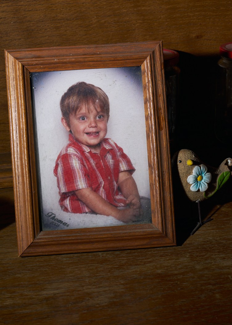 A framed photograph shows a smiling boy and has text on the bottom lefthand corner that reads, “Thomas 2008.”