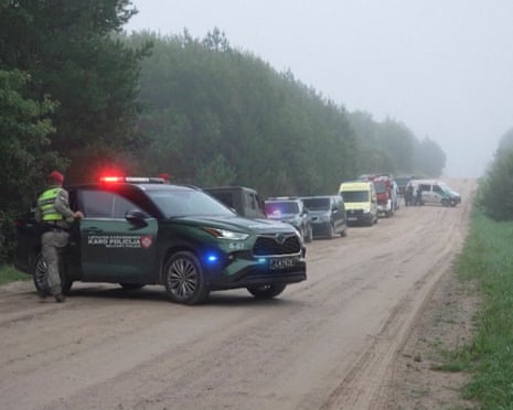 Military police and response vehicles stand parked near the site where a NATO fighter jet shot down a drone near Pratkunai village, Lithuania.