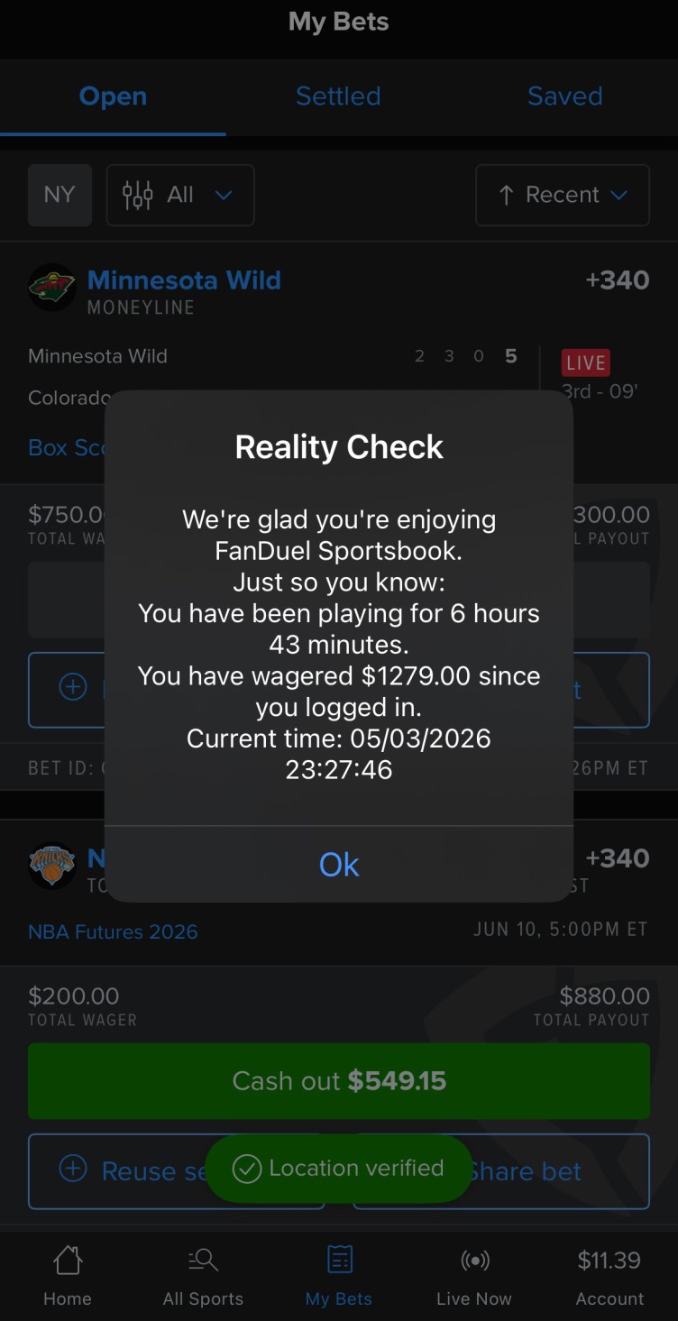 A phone screen with an alert that reads “Reality Check: We’re glad you’re enjoying FanDuel Sportsbook. Just so you know: You have been playing for 6 hours 43 minutes. You have wagered $1279.00 since you logged in. Current time: 05/03/2026 23:27:46.” A button reads “Ok.”