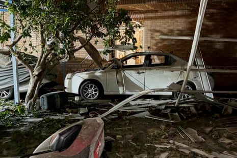 A damaged car among debris.