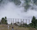 A helicopter flying through the clouds above a river valley