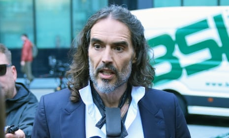 Russell Brand walking towards court.