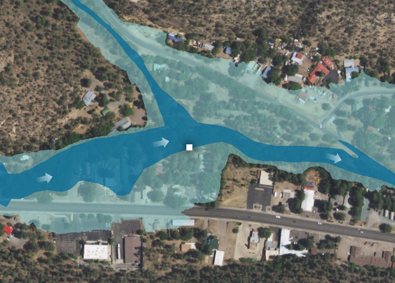 A satellite image shows a road and surrounding buildings in Ruidoso, New Mexico. The road is labeled Sudderth Drive. The Riverview RV Park is labeled on the north side of the road. A dark blue overlay indicates the location of the floodway. A lighter blue overlay indicates the location of the floodplain. The Trotter family camp site is located within the bounds of the floodplain and at the edge of the floodway.