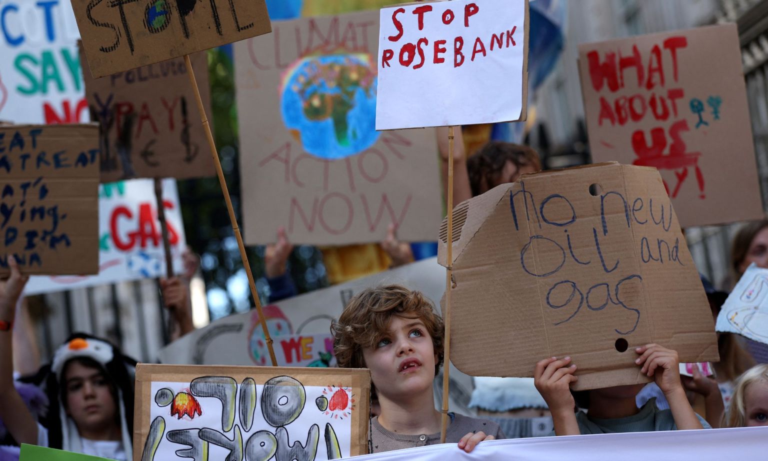 Kids take part in a demonstration to highlight the the impact of record breaking heat on children due to climate change, near Downing Street in central London on September 1, 2026. 